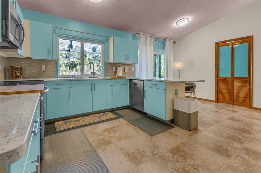 1035 Sirus Trail Sarasota, FL 34232 - Photo 11 of 48 a kitchen with window and cabinets