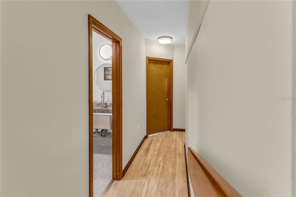 1035 Sirus Trail Sarasota, FL 34232 - Photo 22 of 48 a view of a hallway with wooden floor