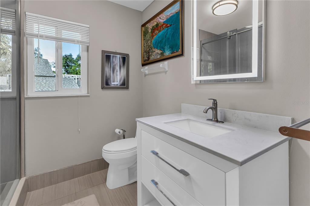 1035 Sirus Trail Sarasota, FL 34232 - Photo 23 of 48 a bathroom with a toilet sink and mirror