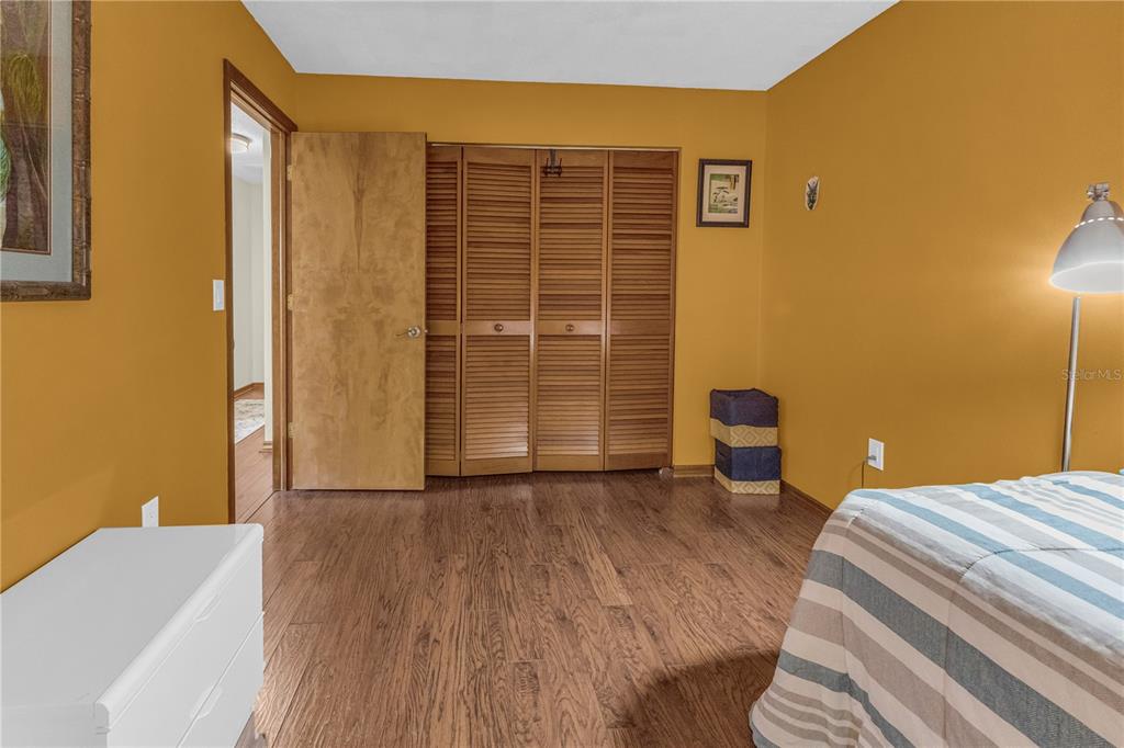 1035 Sirus Trail Sarasota, FL 34232 - Photo 26 of 48 a view of a bedroom with wooden floor and bedroom