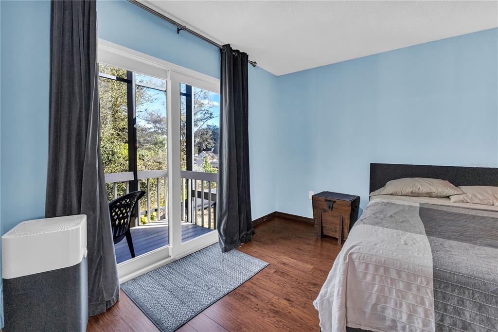 1035 Sirus Trail Sarasota, FL 34232 - Photo 33 of 48 a bedroom with a bed and wooden floor