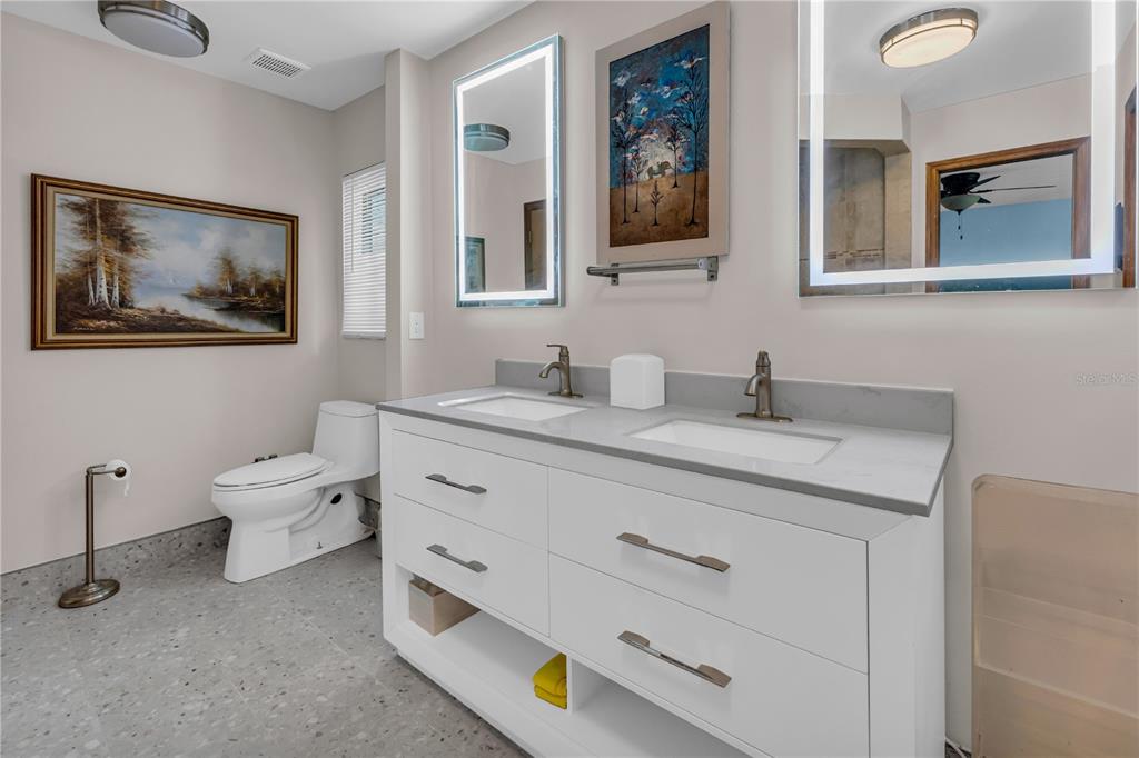 1035 Sirus Trail Sarasota, FL 34232 - Photo 35 of 48 a bathroom with a toilet a sink and mirror