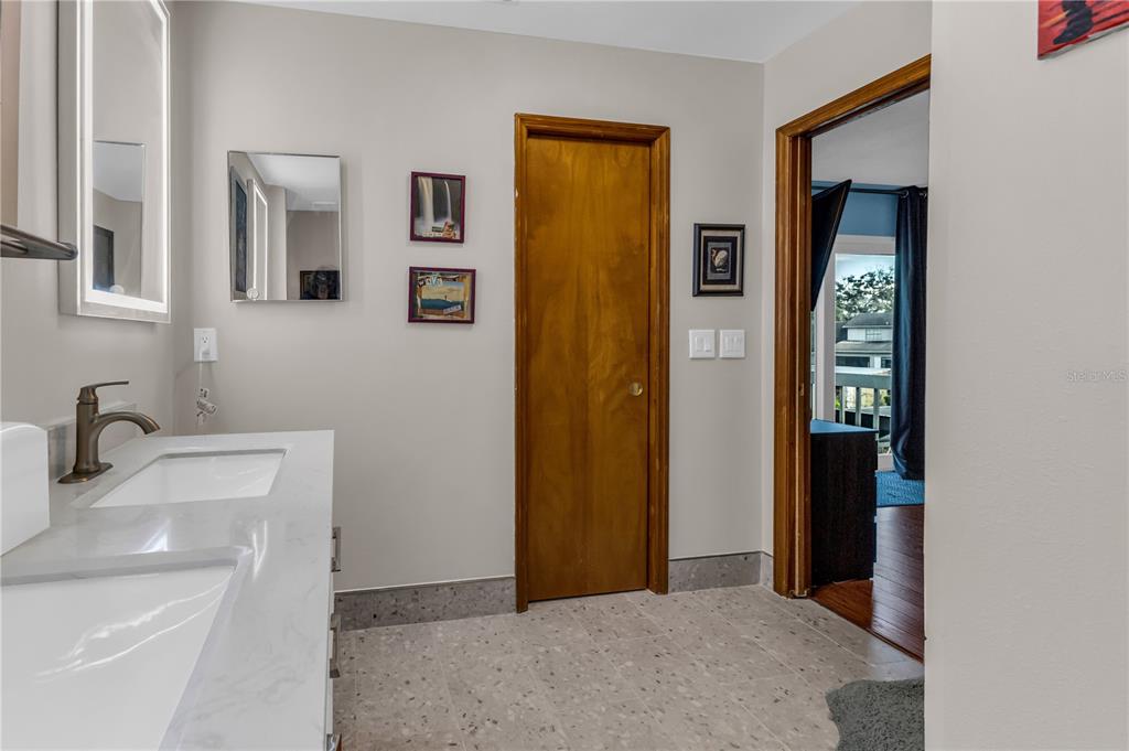 1035 Sirus Trail Sarasota, FL 34232 - Photo 36 of 48 a en suite bathroom with a sink and mirror