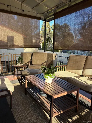 a view of a roof deck with table and chairs with wooden floor