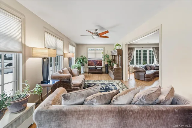 a living room with furniture ceiling fan and a window