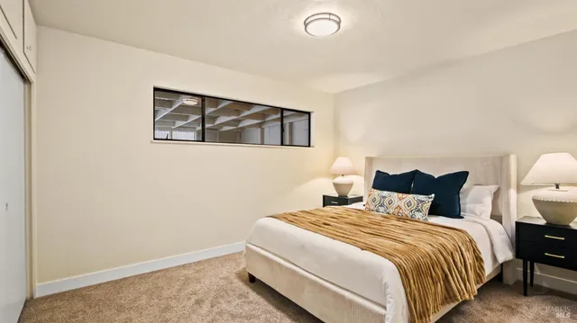 a bedroom with a bed and a night stand