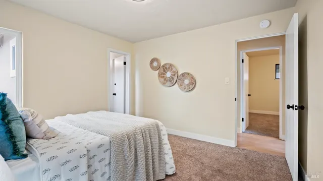a bedroom with a bed and a painting on the wall