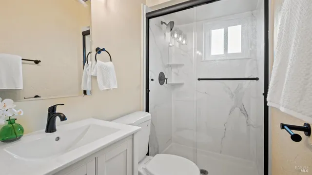 a bathroom with a sink toilet and shower