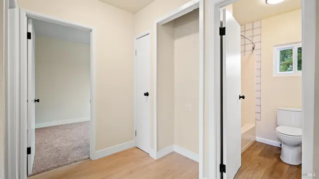 a view of bathroom with a toilet shower and a sink