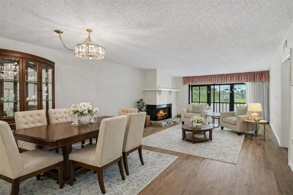 a view of a dining room with furniture wooden floor and chandelier