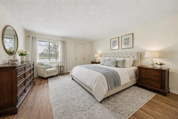 a bedroom with a bed and a night stand
