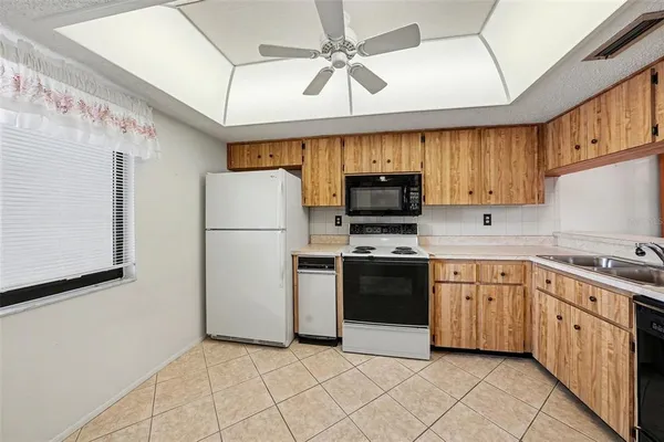 a kitchen with stainless steel appliances granite countertop a refrigerator a stove top oven a sink and dishwasher