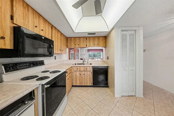 a kitchen with a stove a sink and a microwave