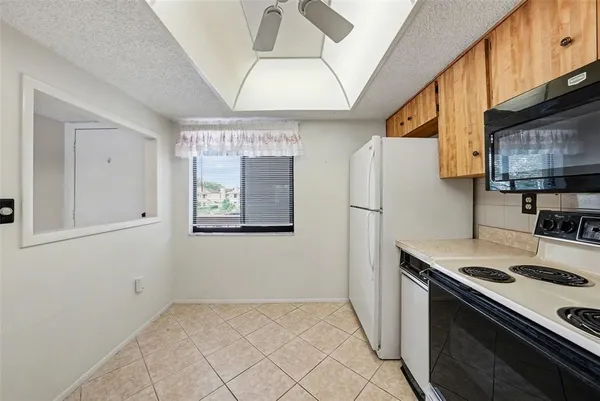 a kitchen with stainless steel appliances granite countertop a refrigerator and a stove