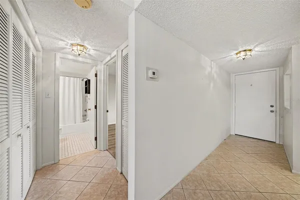 a view of a bathroom with mirror and shower