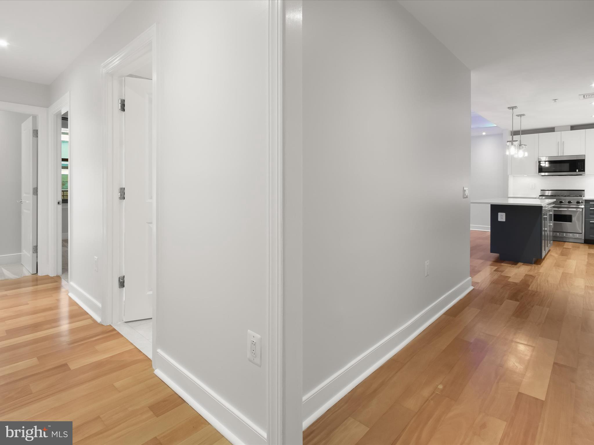 2425 L Street Northwest, Unit 239 Washington, DC 20037 - Photo 13 of 43 a view of a kitchen from the hallway