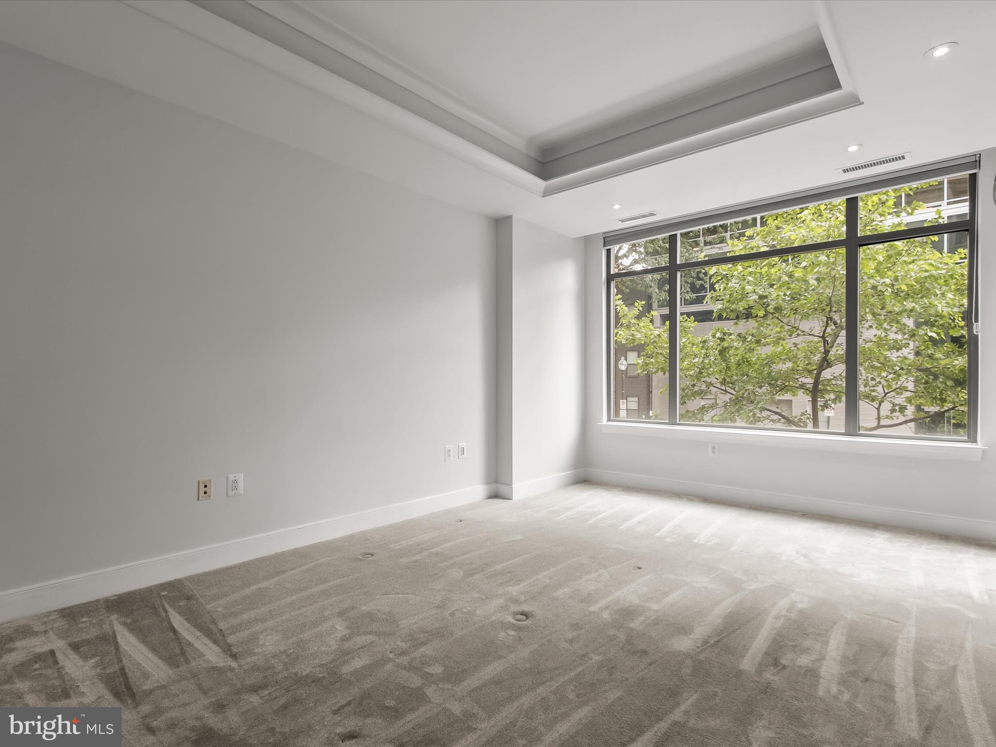 2425 L Street Northwest, Unit 239 Washington, DC 20037 - Photo 14 of 43 a view of a big room with windows and chandelier fan
