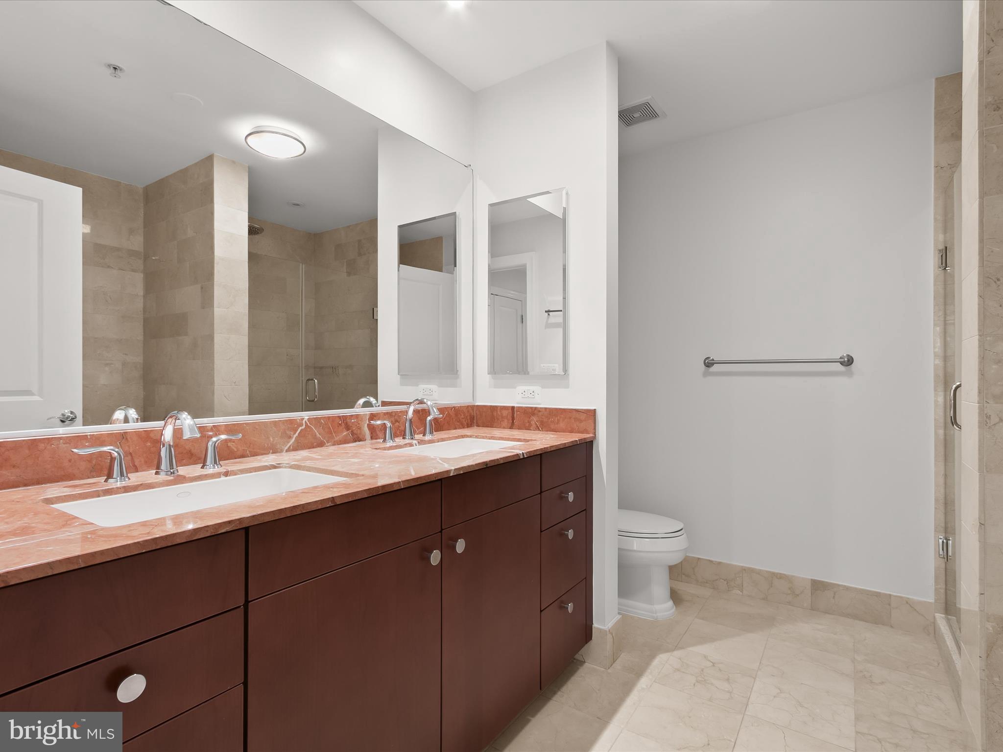 2425 L Street Northwest, Unit 239 Washington, DC 20037 - Photo 21 of 43 a bathroom with a double vanity sink toilet and a mirror