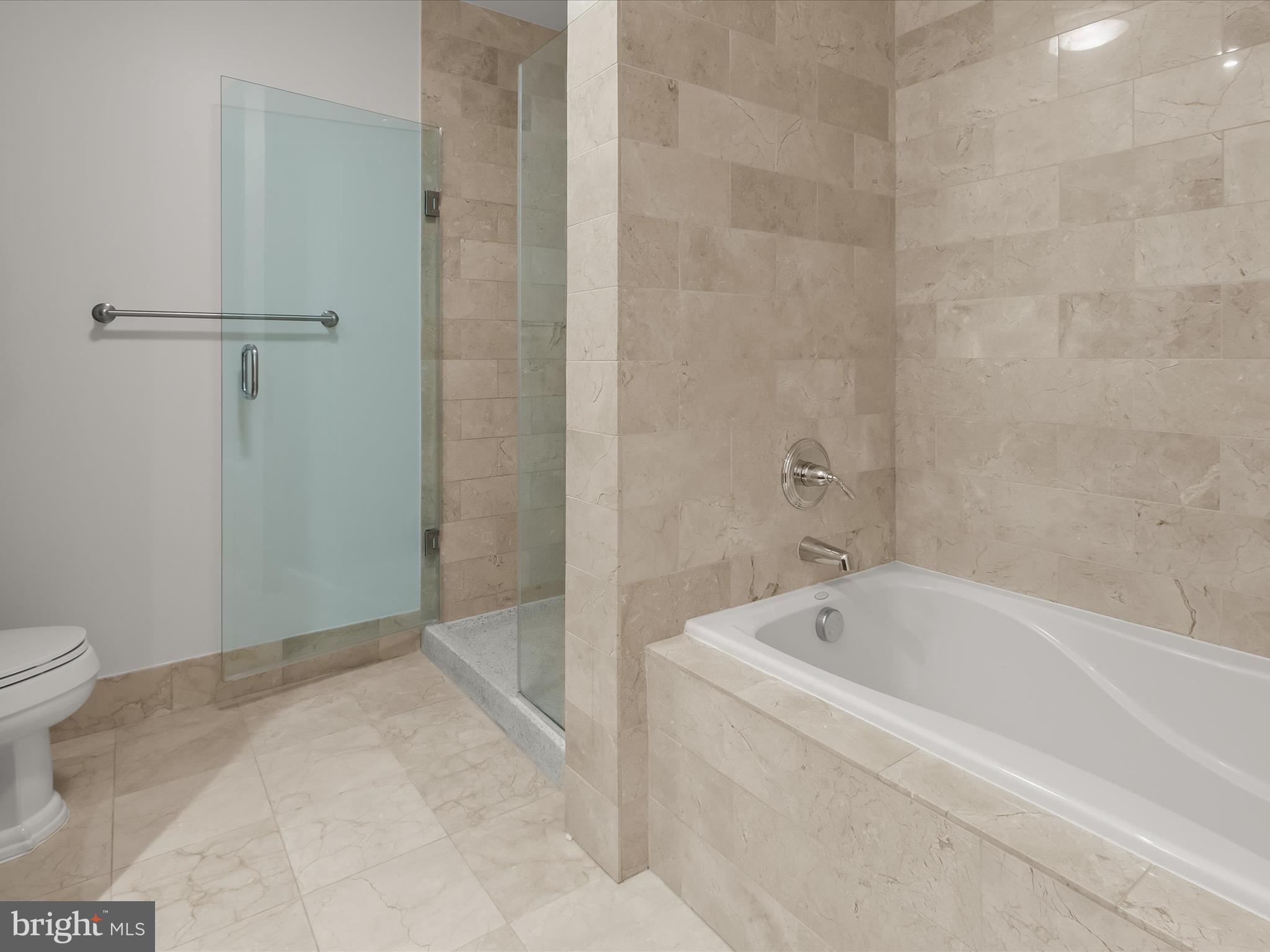 2425 L Street Northwest, Unit 239 Washington, DC 20037 - Photo 24 of 43 a white bath tub sitting next to a toilet