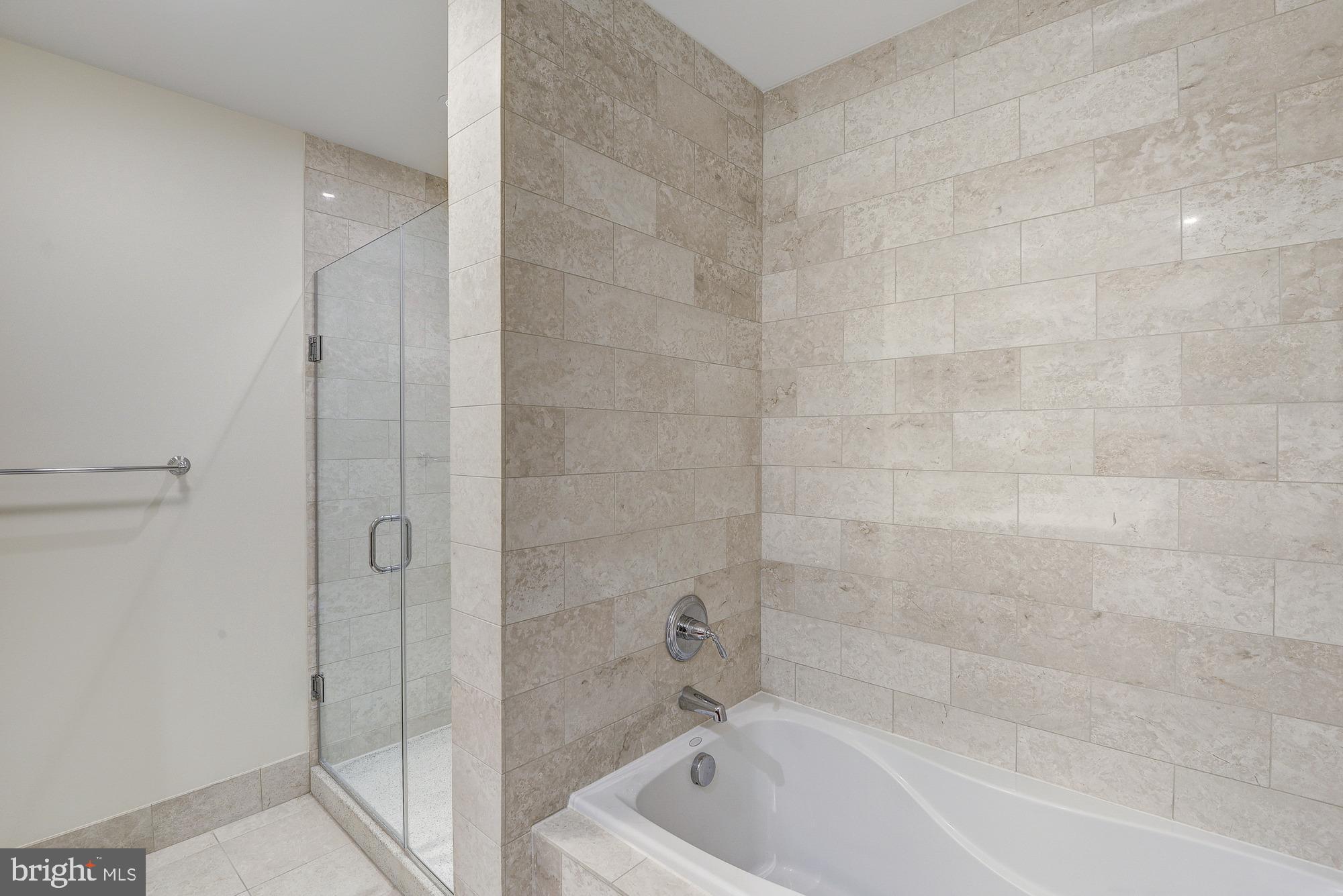 2425 L Street Northwest, Unit 239 Washington, DC 20037 - Photo 25 of 43 a bathroom with a bathtub and shower