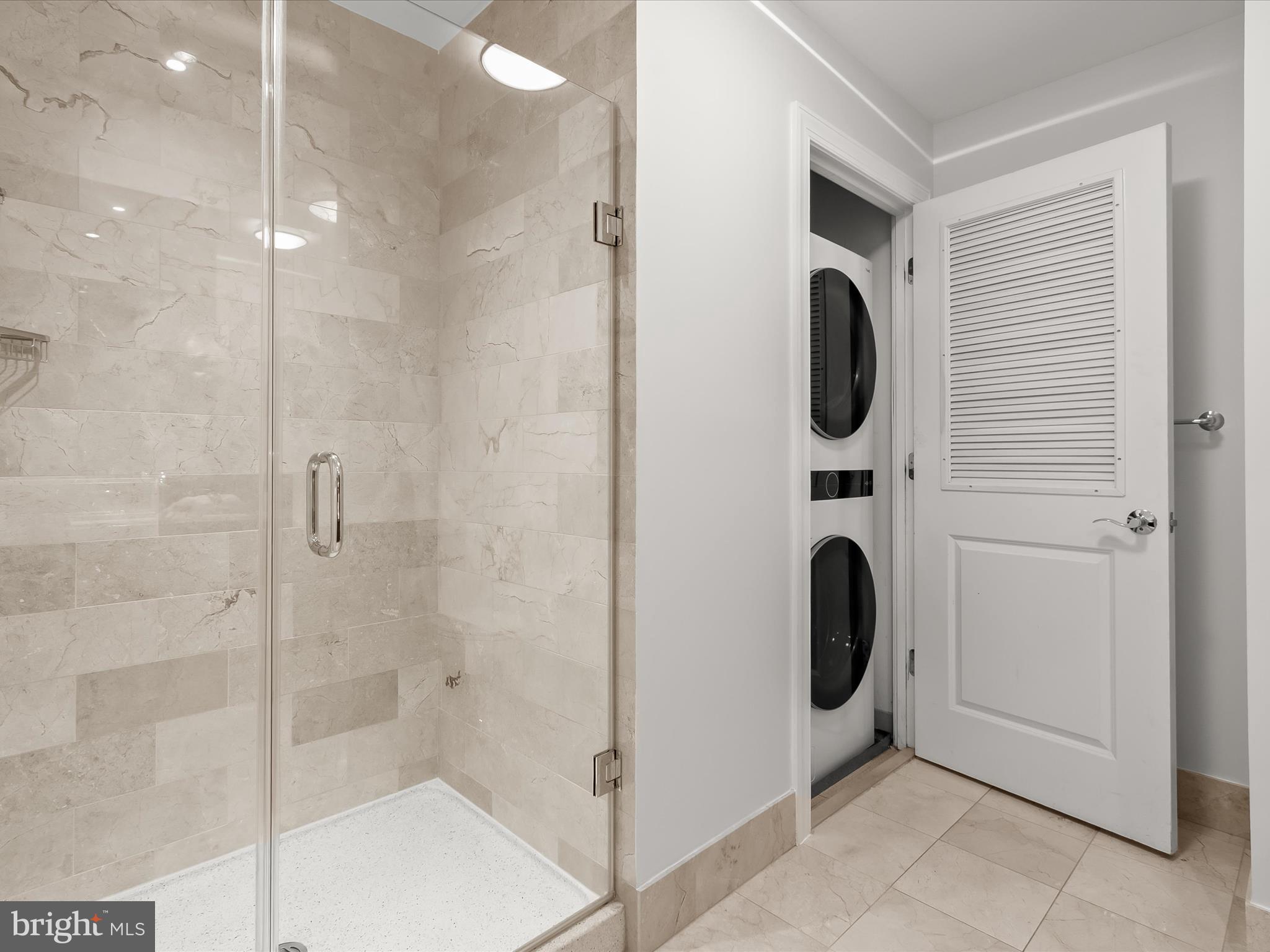 2425 L Street Northwest, Unit 239 Washington, DC 20037 - Photo 31 of 43 a bathroom with a shower and mirror