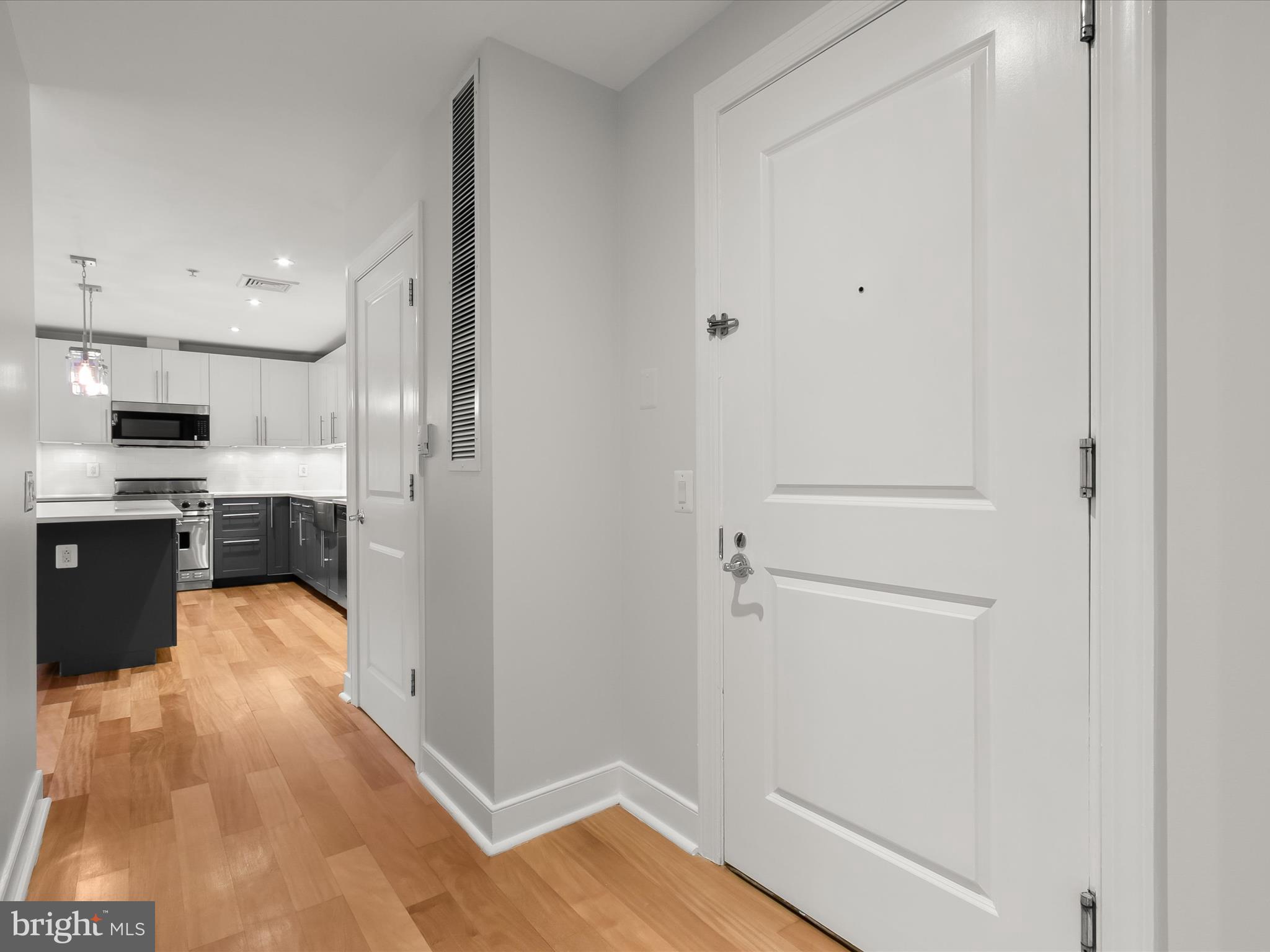 2425 L Street Northwest, Unit 239 Washington, DC 20037 - Photo 5 of 43 a view of kitchen with wooden floor