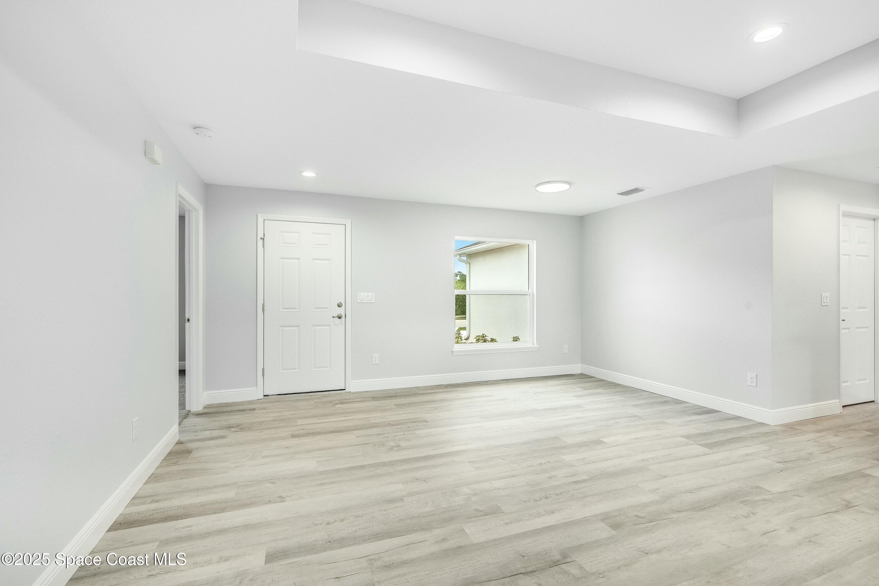1341 Defender Street Northwest Palm Bay, FL 32907 - Photo 11 of 38 wooden floor in an empty room