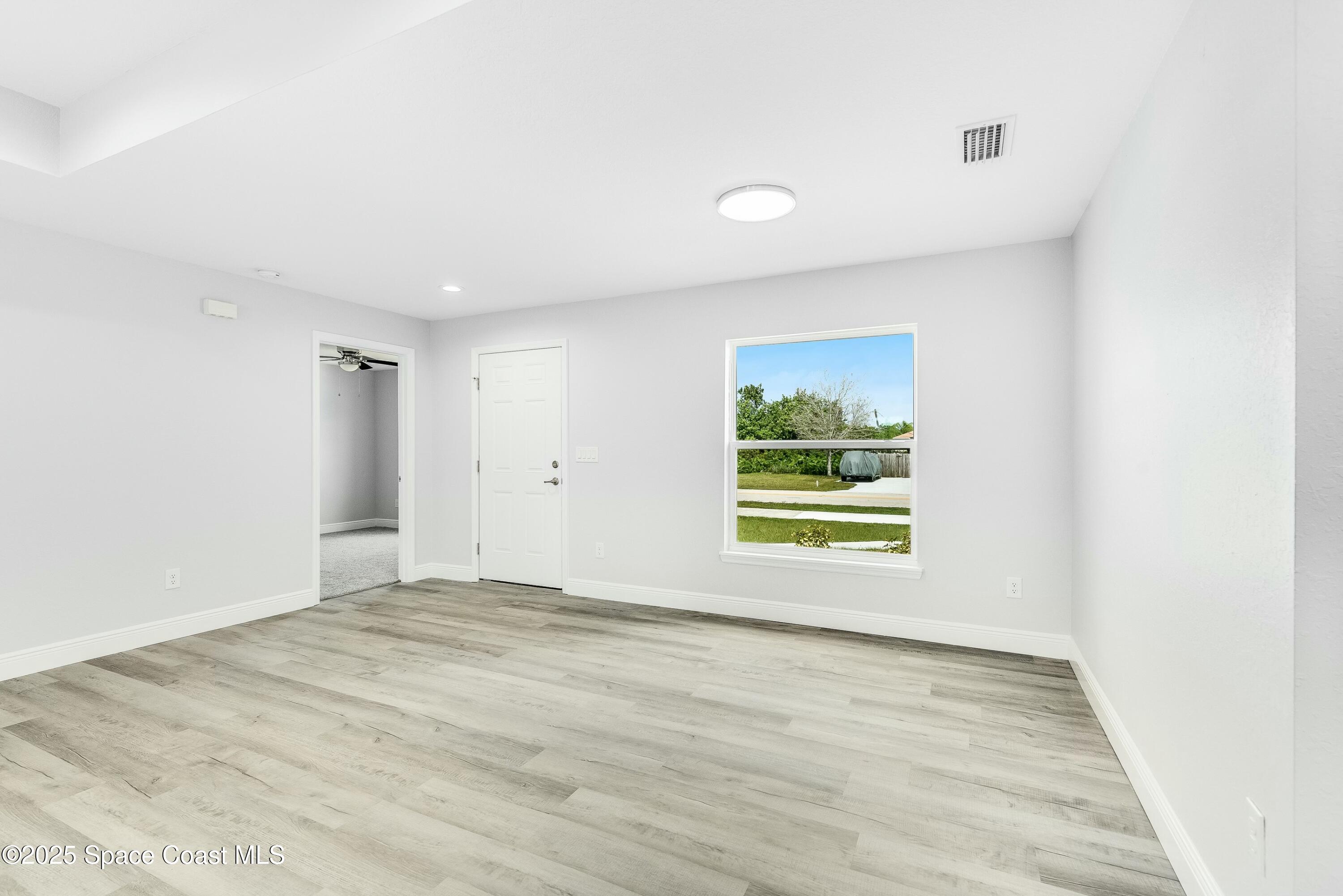 1341 Defender Street Northwest Palm Bay, FL 32907 - Photo 12 of 38 a view of an empty room with a window