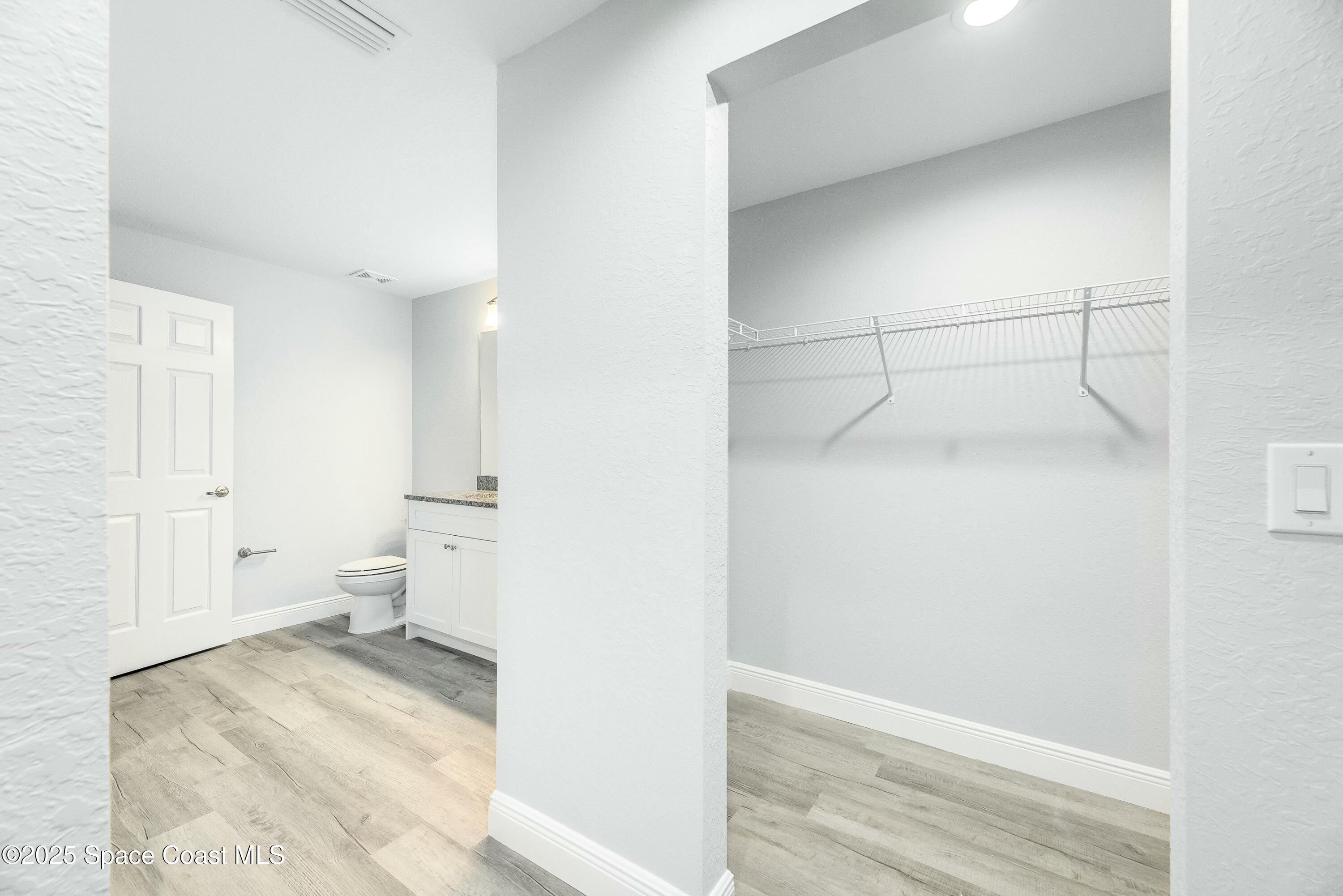 1341 Defender Street Northwest Palm Bay, FL 32907 - Photo 23 of 38 a view of a room with wooden floor