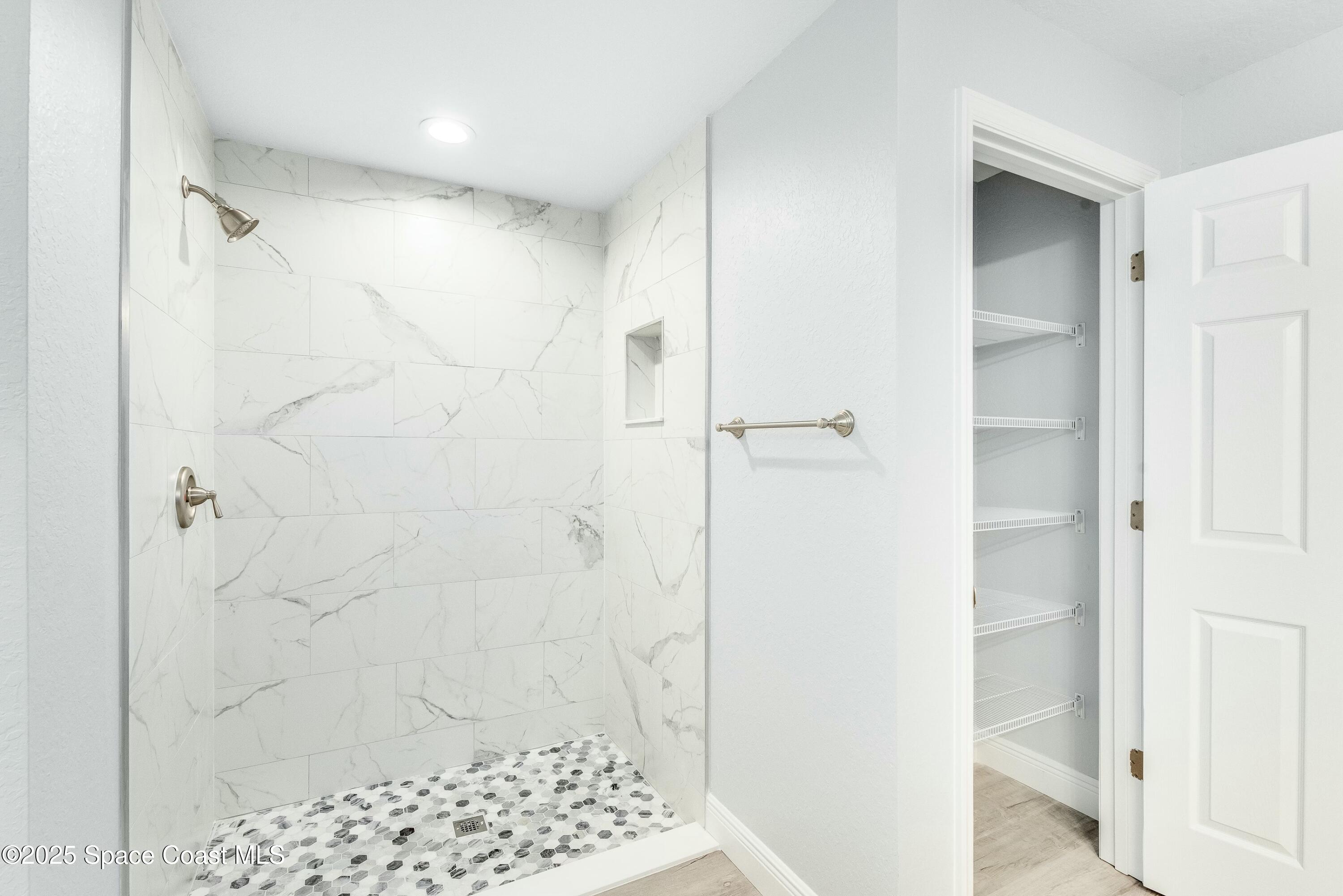 1341 Defender Street Northwest Palm Bay, FL 32907 - Photo 27 of 38 a bathroom with a shower and a sink