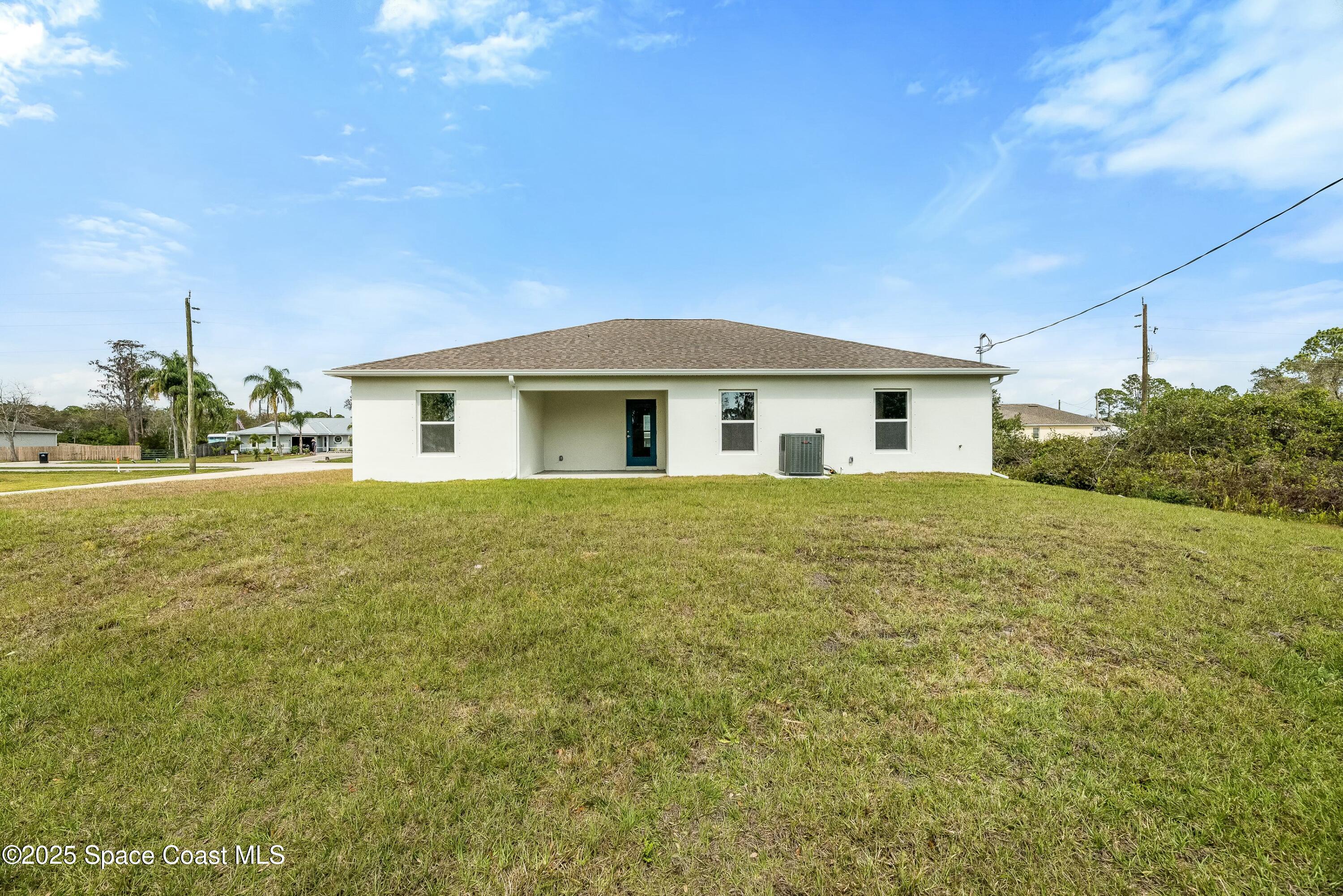 1341 Defender Street Northwest Palm Bay, FL 32907 - Photo 35 of 38 a view of a house with a yard