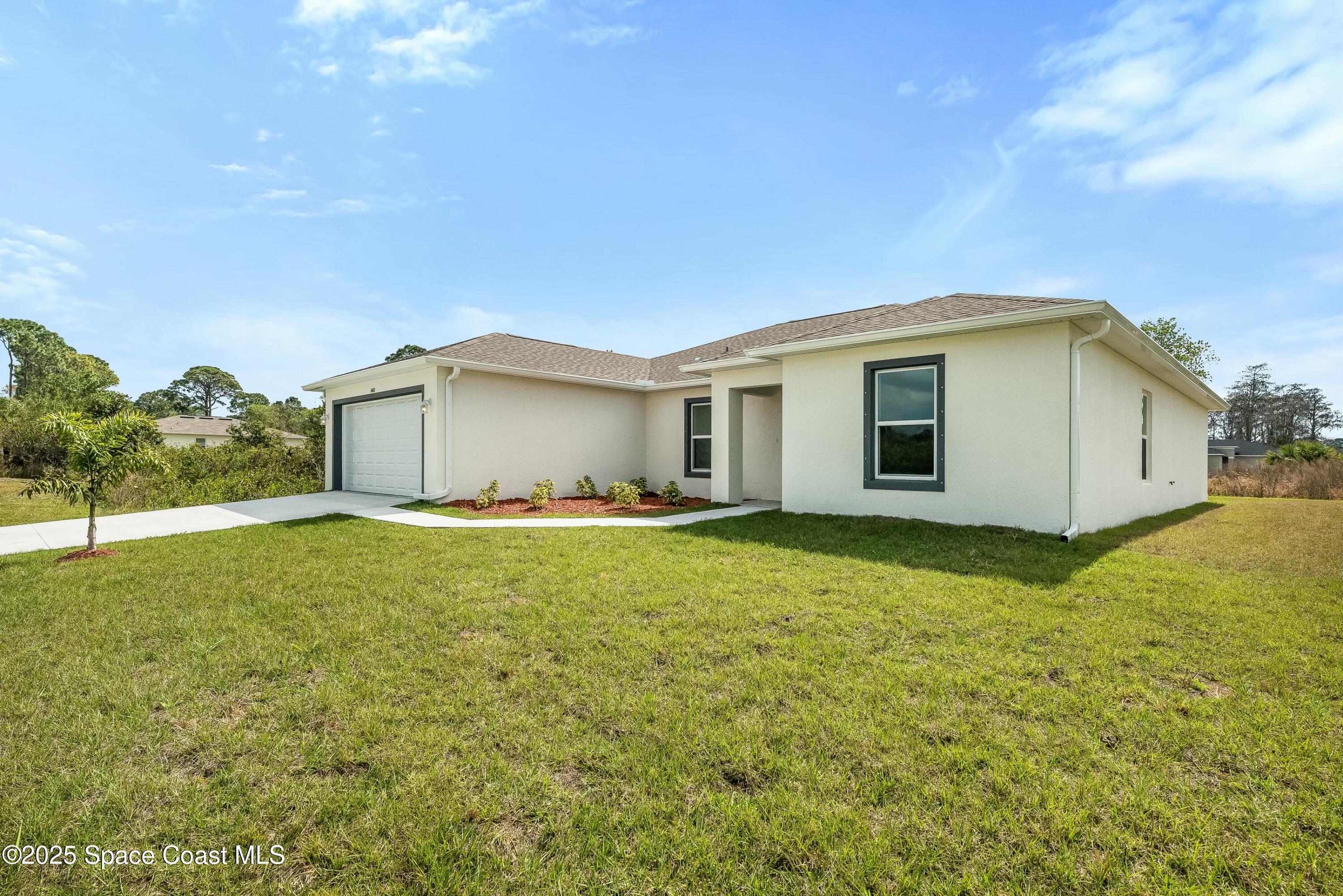 1341 Defender Street Northwest Palm Bay, FL 32907 - Photo 4 of 38 a house view with a garden space