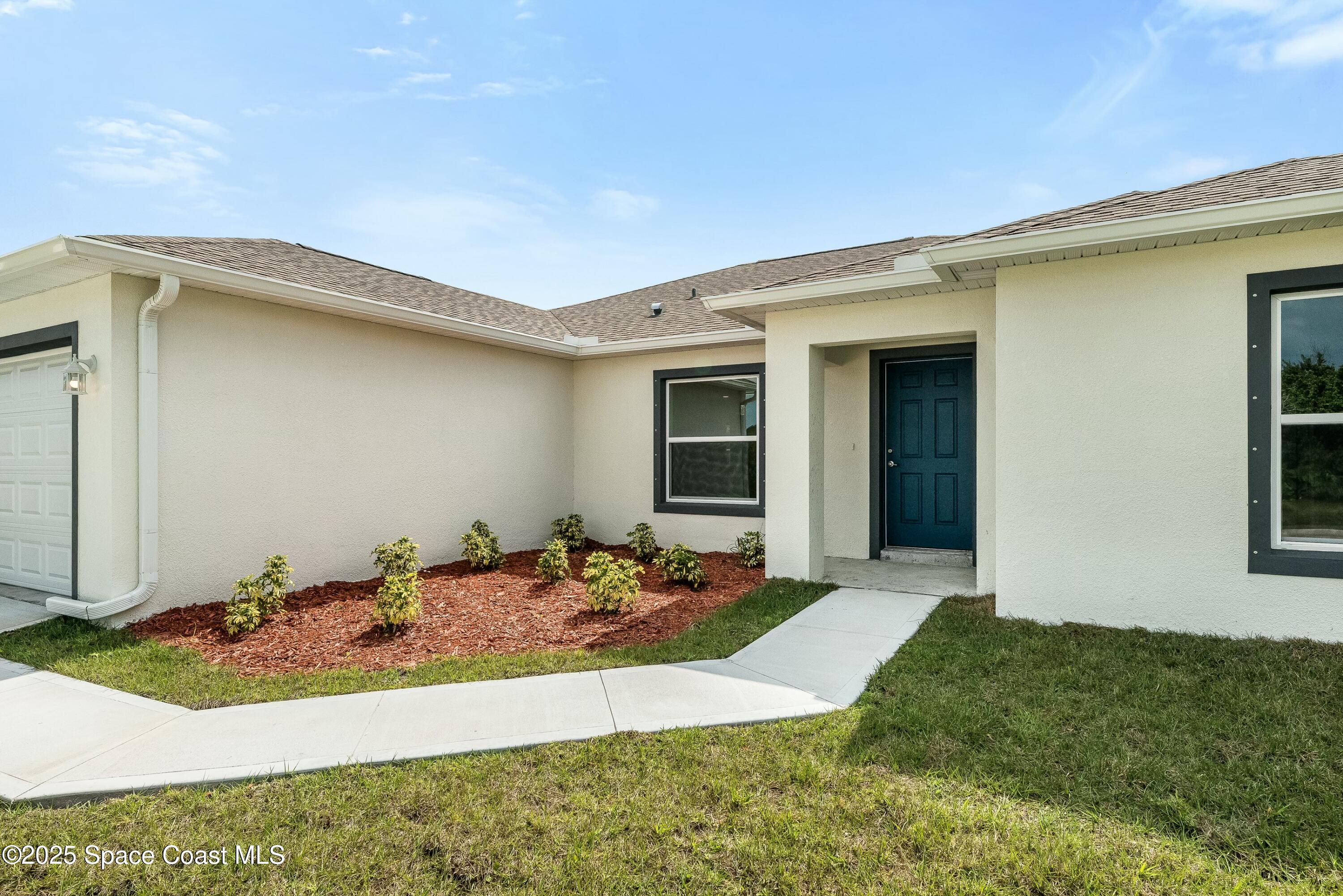 1341 Defender Street Northwest Palm Bay, FL 32907 - Photo 5 of 38 a front view of a house