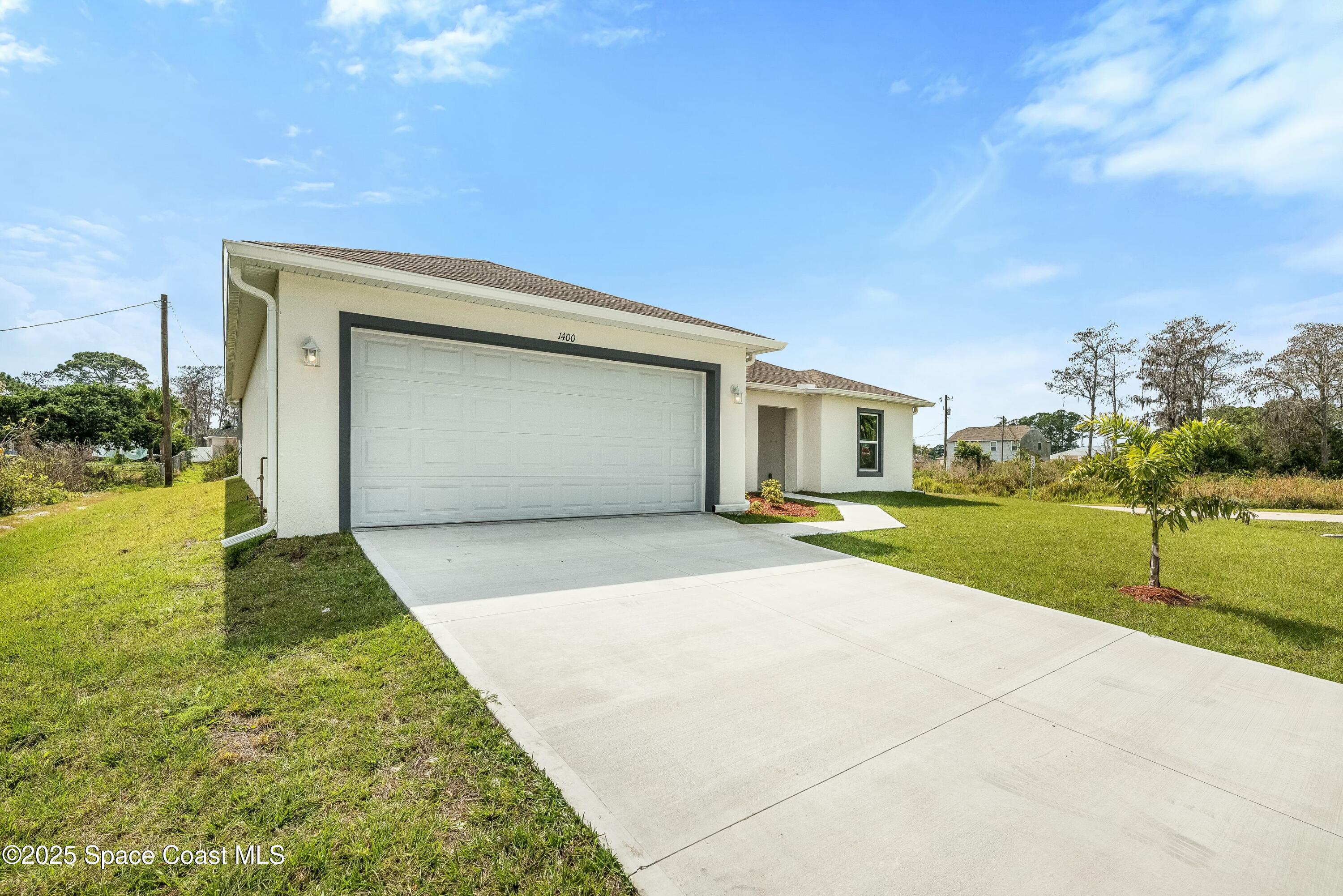 1341 Defender Street Northwest Palm Bay, FL 32907 - Photo 6 of 38 a front view of house with yard