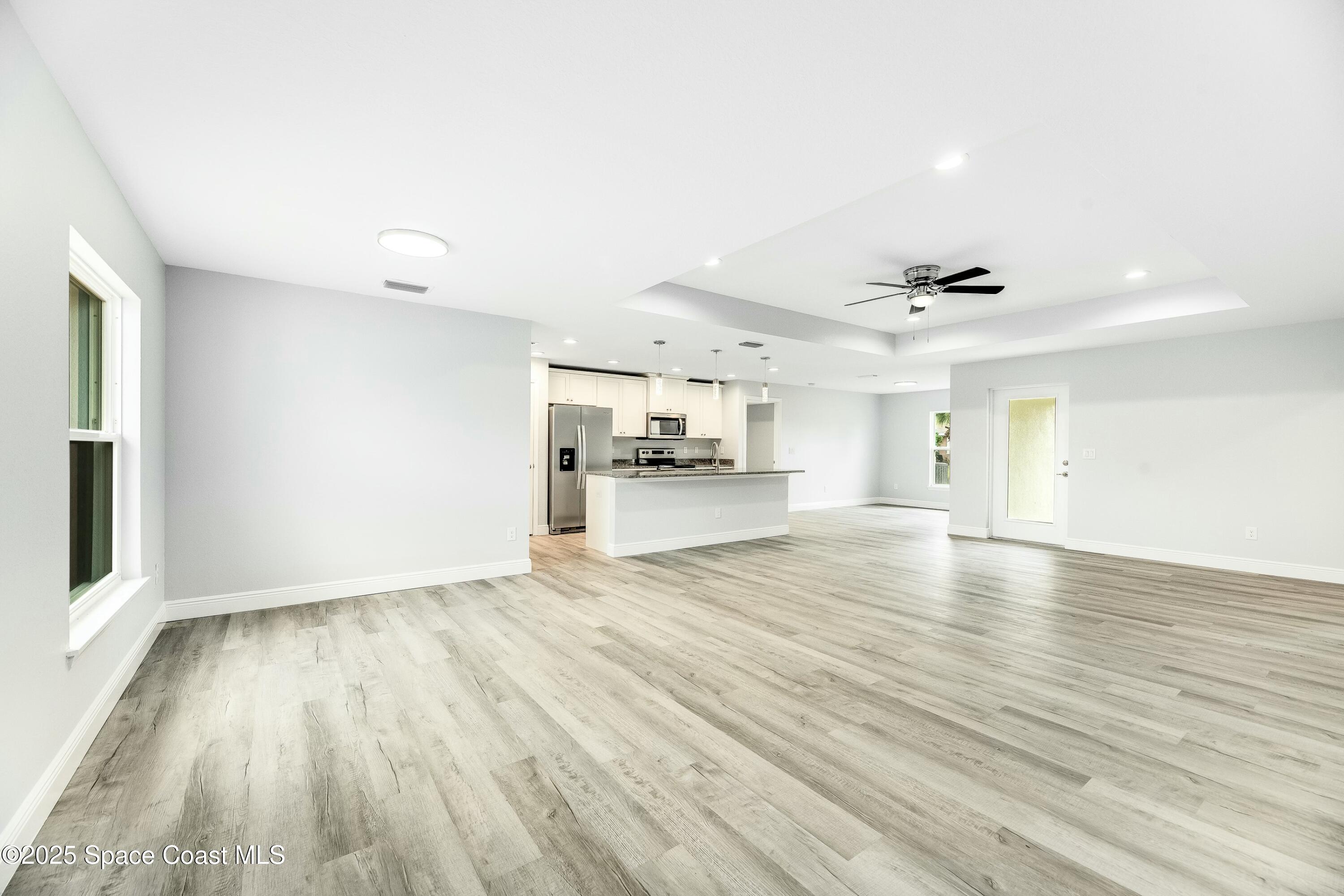 1341 Defender Street Northwest Palm Bay, FL 32907 - Photo 7 of 38 wooden floor in an empty room with a window
