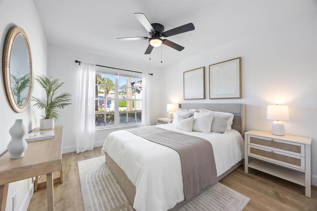 8330 Bermuda Sound Way Boynton Beach, FL 33436 - Photo 13 of 52 a bedroom with a bed and a chandelier