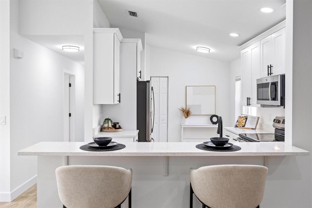 8330 Bermuda Sound Way Boynton Beach, FL 33436 - Photo 3 of 52 a kitchen with sink a stove and chairs