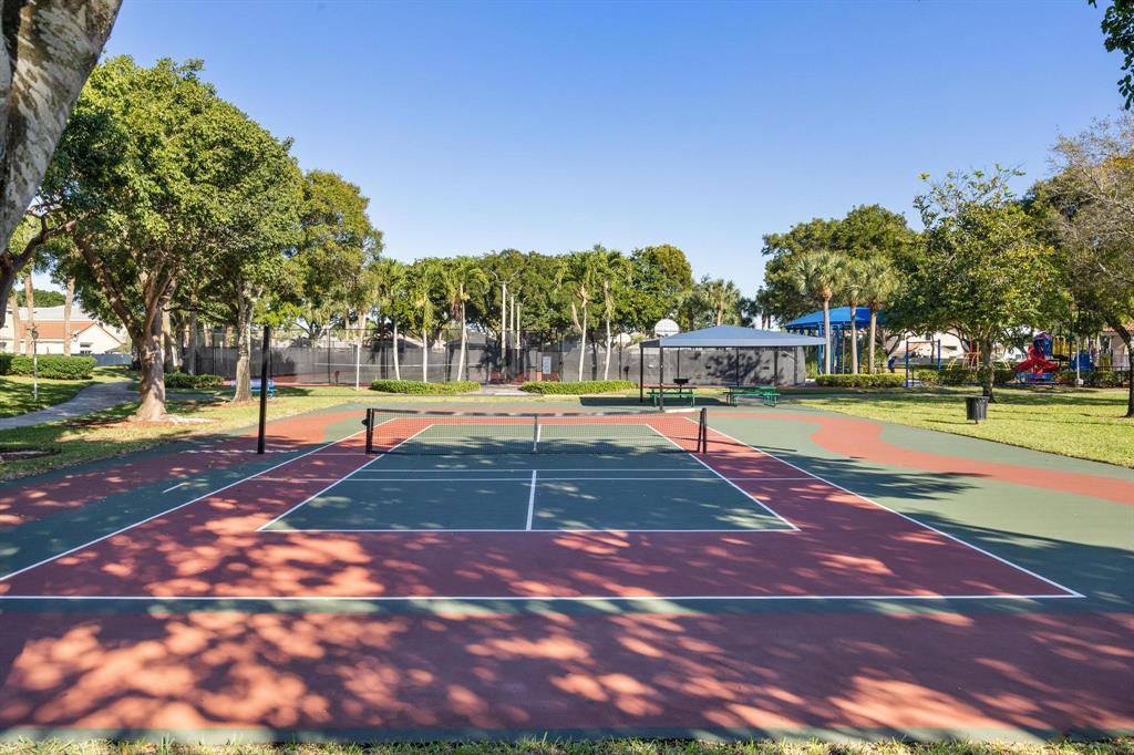 8330 Bermuda Sound Way Boynton Beach, FL 33436 - Photo 33 of 52 a view of a tennis ground with large trees