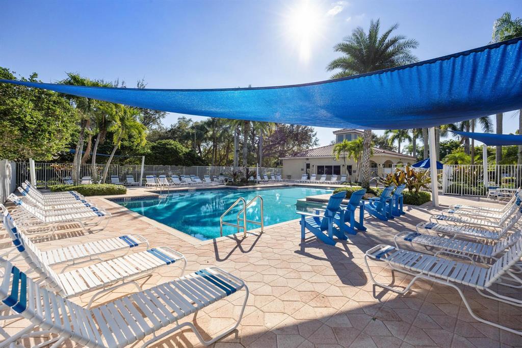 8330 Bermuda Sound Way Boynton Beach, FL 33436 - Photo 36 of 52 a view of a patio with table and chairs potted plants with palm trees