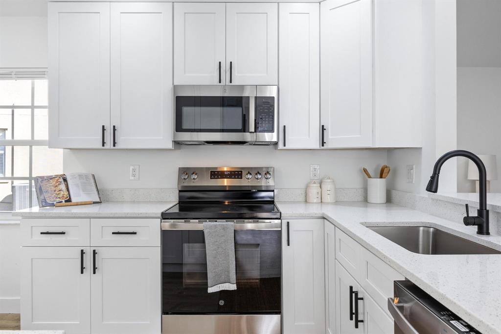 8330 Bermuda Sound Way Boynton Beach, FL 33436 - Photo 8 of 52 a kitchen with stainless steel appliances granite countertop a sink a stove a microwave and cabinets