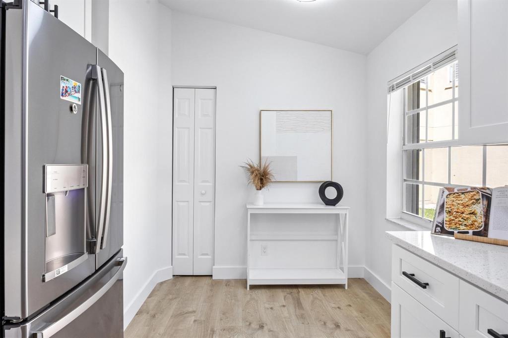 8330 Bermuda Sound Way Boynton Beach, FL 33436 - Photo 9 of 52 a kitchen with a refrigerator and white cabinets