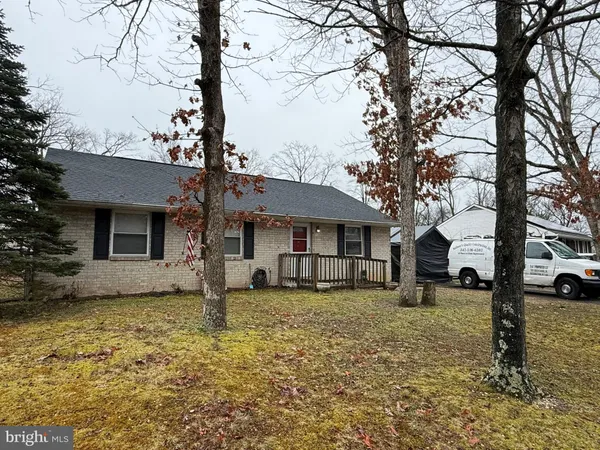 a view of a house with a yard covered in snow