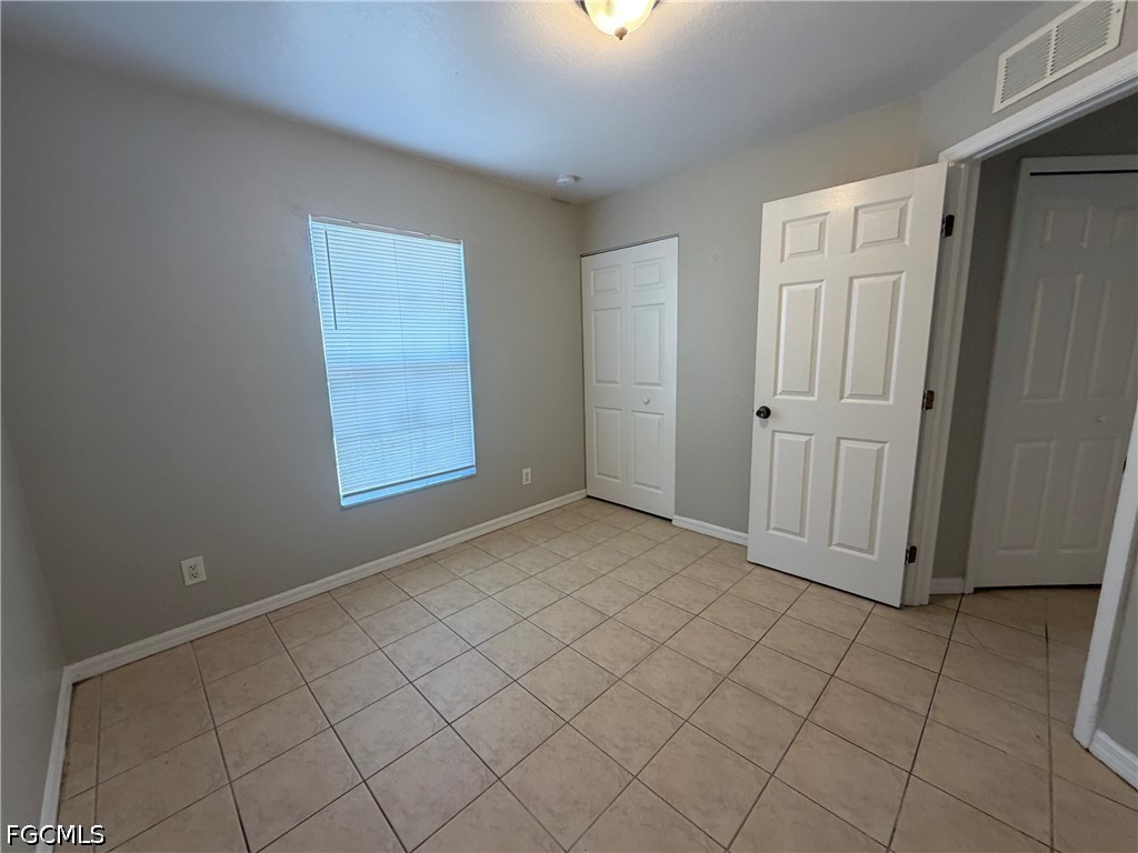 4535 26th Street Southwest Lehigh Acres, FL 33973 - Photo 11 of 14 an empty room with windows