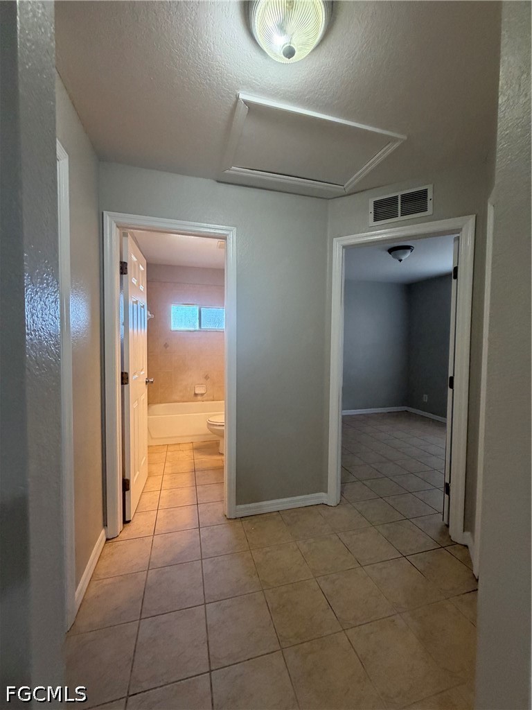 4535 26th Street Southwest Lehigh Acres, FL 33973 - Photo 12 of 14 a view of a hallway to rooms and wooden floor