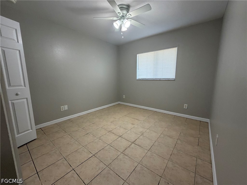 4535 26th Street Southwest Lehigh Acres, FL 33973 - Photo 13 of 14 an empty room with ceiling fan and window