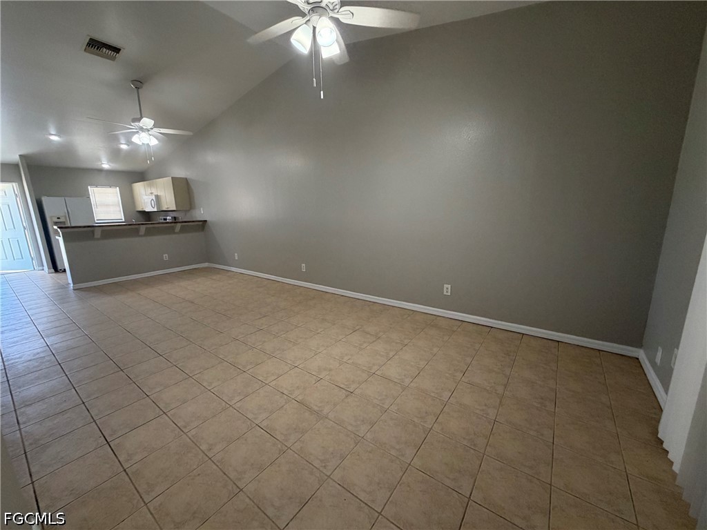 4535 26th Street Southwest Lehigh Acres, FL 33973 - Photo 7 of 14 an empty room with staircase and ceiling fan