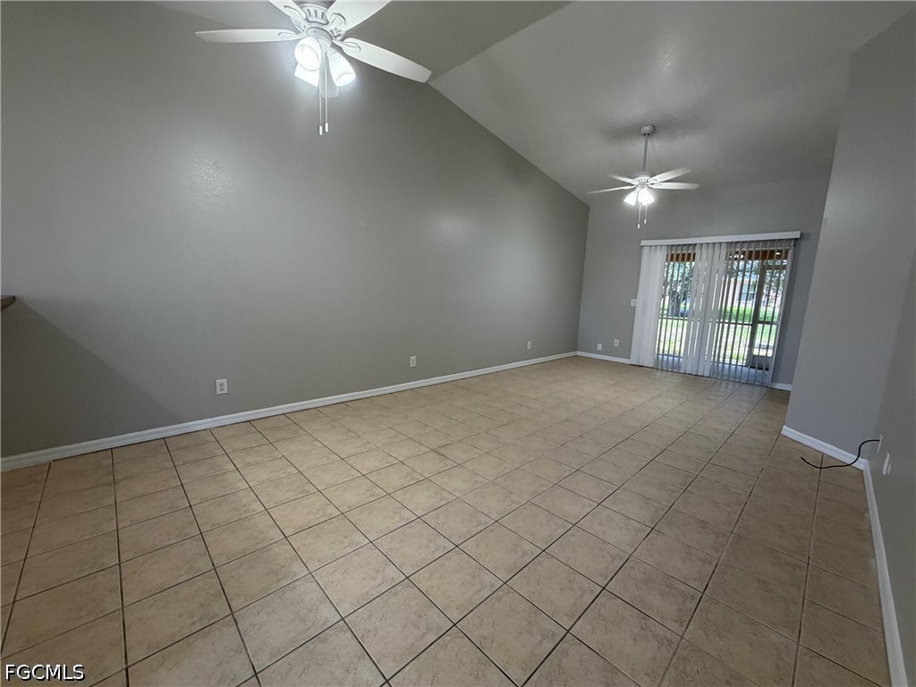 4535 26th Street Southwest Lehigh Acres, FL 33973 - Photo 8 of 14 an empty room with chandelier fan and windows