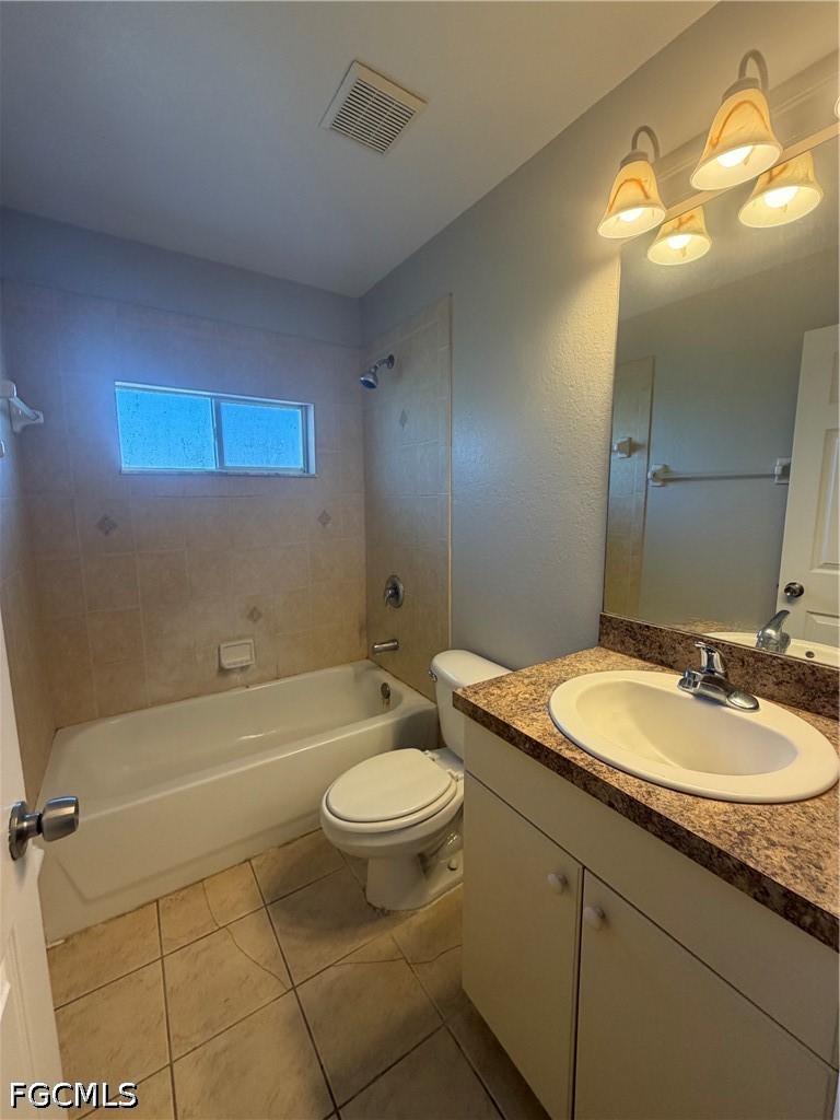 4535 26th Street Southwest Lehigh Acres, FL 33973 - Photo 9 of 14 a bathroom with a granite countertop sink toilet and a mirror
