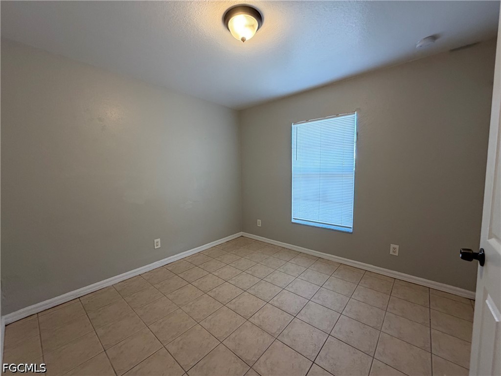 4535 26th Street Southwest Lehigh Acres, FL 33973 - Photo 10 of 14 an empty room with windows