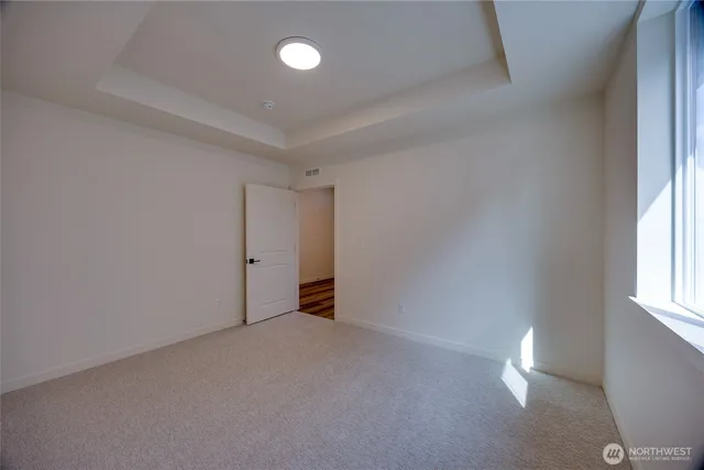 a view of an empty room and a window